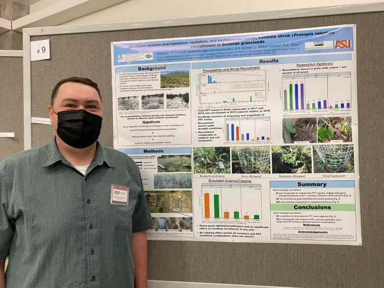 Austin Rutherford in front of his poster